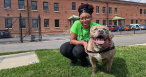 person sitting with dog outside